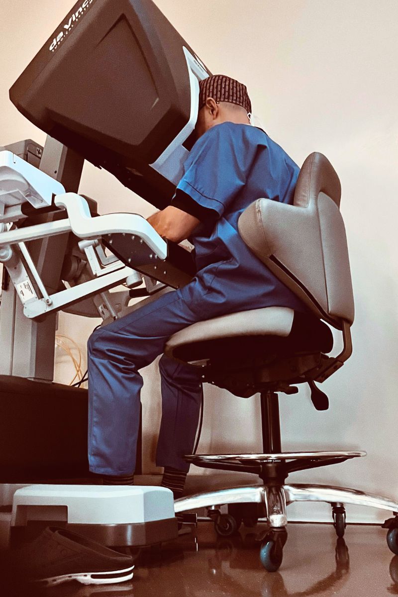Dr Inan seated at the robotic console, operating the surgical system during a minimally invasive procedure.