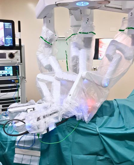 Robotic surgical console and articulated instruments used for minimally invasive robotic inguinal hernia repair in a sterile operating room in Geneva.